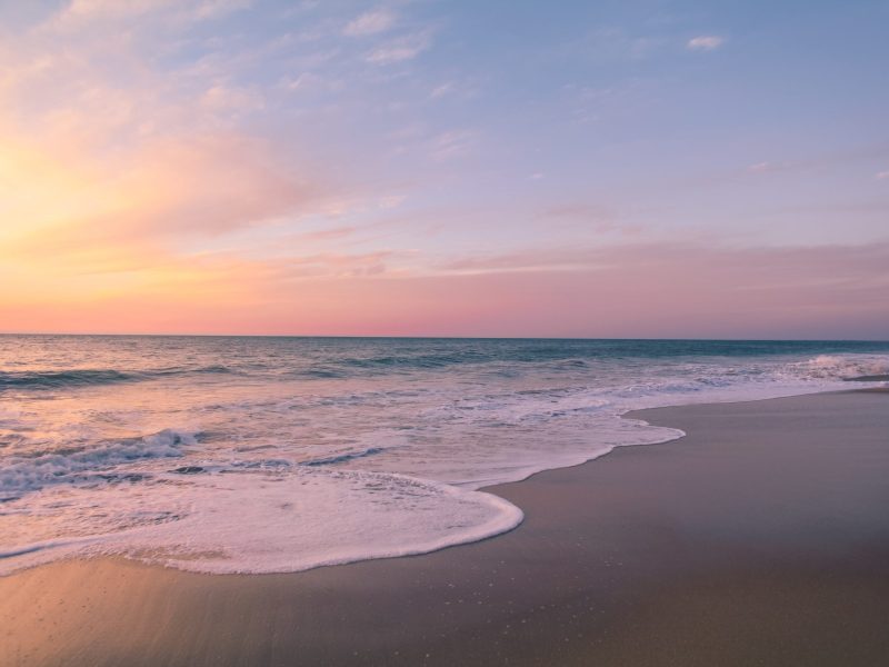 beautiful-shot-colorful-sunset-beach-scaled